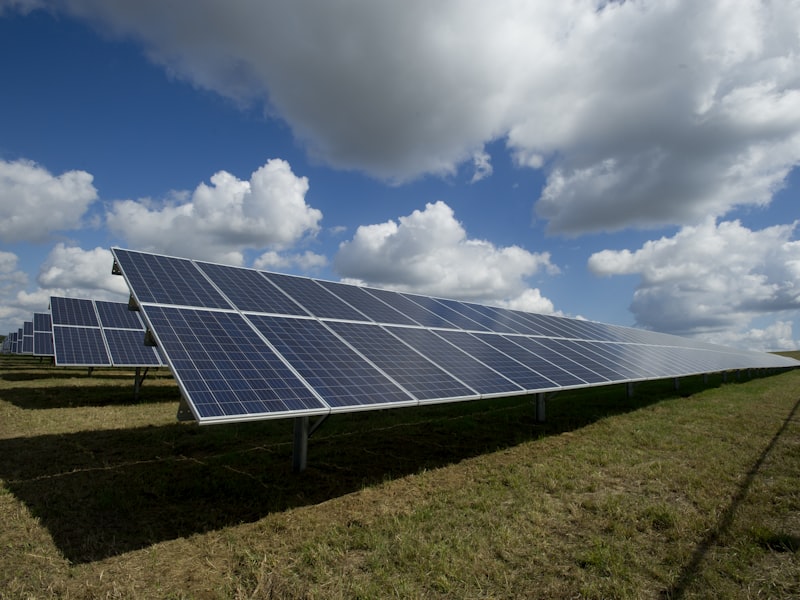 Technician cleaning rooftop solar panels to restore energy efficiency